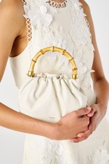 Profile view of model wearing the Oroton Gretel Mini Top Handle in Clotted Cream and Smooth leather for Women