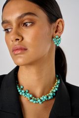 Profile view of model wearing the Oroton Jupiter Necklace in Worn Gold/Turquoise and Brass for Women