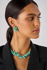 Profile view of model wearing the Oroton Jupiter Necklace in Worn Gold/Turquoise and Brass for Women