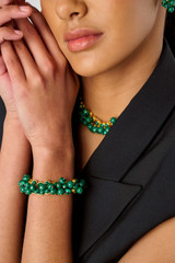 Profile view of model wearing the Oroton Jupiter Necklace in Worn Gold/Malachite and Brass for Women