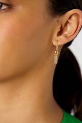 Profile view of model wearing the Oroton Addie Drop Earrings in 18K Gold and Recycled 925 Sterling Silver for Women