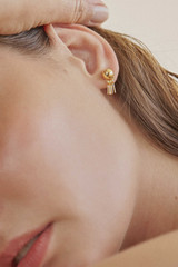 Profile view of model wearing the Oroton Addie Studs in 18K Gold and Sustainably sourced 925 Sterling Silver for Women