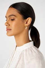 Profile view of model wearing the Oroton Melody Multi Pearl Huggies in 18K Gold and Recycled 925 Sterling Silver for Women