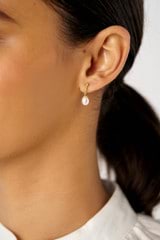 Profile view of model wearing the Oroton Melody Drop Studs in 18K Gold and Recycled 925 Sterling Silver for Women