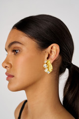 Profile view of model wearing the Oroton Conch Large Earrings in Worn Gold/Clear and Brass for Women