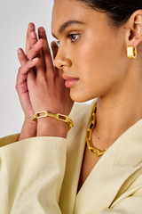 Profile view of model wearing the Oroton Isla Bracelet in Worn Gold and Brass for Women