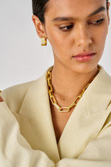 Profile view of model wearing the Oroton Isla Necklace in Worn Gold and Brass for Women