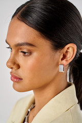 Profile view of model wearing the Oroton Isla Wide Hoop in Silver and Brass for Women