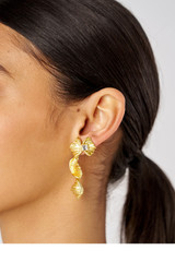 Profile view of model wearing the Oroton Conch Mini Jewel Stud in Worn Gold/Clear and Brass for Women