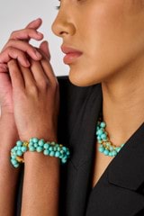 Profile view of model wearing the Oroton Jupiter Bracelet in Worn Gold/Turquoise and Brass for Women