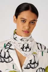 Profile view of model wearing the Oroton Spring Tulip Silk Scarf in Clotted Cream and 100% silk for Women