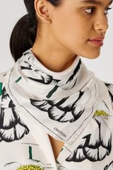 Profile view of model wearing the Oroton Spring Tulip Silk Scarf in Clotted Cream and 100% silk for Women