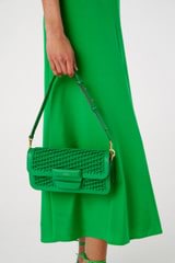 Profile view of model wearing the Oroton Dahlia Collectable Small Day Bag in Jewel Green and Smooth leather. Handwoven leather for Women