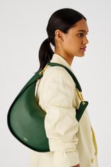 Profile view of model wearing the Oroton Quinn Hobo in Dark Treehouse and Smooth leather for Women