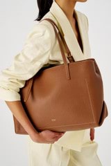 Profile view of model wearing the Oroton Margot Baby Bag in Whiskey and Pebble leather for Women