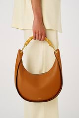 Profile view of model wearing the Oroton Quinn Hobo in Amber and Smooth leather for Women
