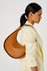 Profile view of model wearing the Oroton Quinn Hobo in Amber and Smooth leather for Women