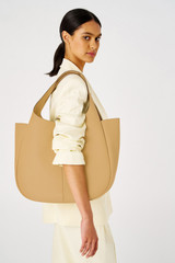 Profile view of model wearing the Oroton Emilia Large Tote in Camel and Pebble leather for Women