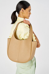 Profile view of model wearing the Oroton Emilia Tote in Camel and Pebble leather for Women