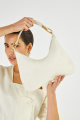 Profile view of model wearing the Oroton North Hobo in Clotted Cream and Smooth Leather for Women