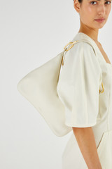 Profile view of model wearing the Oroton North Hobo in Clotted Cream and Smooth Leather for Women