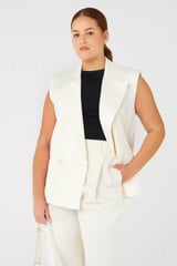 Profile view of model wearing the Oroton Sleeveless Waiter's Jacket in Cream and 58% viscose, 42% linen for Women