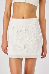 Profile view of model wearing the Oroton Lace Flower Mini Skirt in Soft Cream and sheer organdy: 100% Cotton 
skirt base: 100% Linen for Women