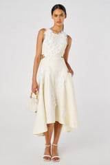 Profile view of model wearing the Oroton Lace Flower Midi Dress in Soft Cream and 100% Linen for Women
