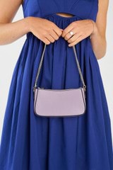 Profile view of model wearing the Oroton Inez Chain Wristlet in Lilac and Saffiano Leather for Women