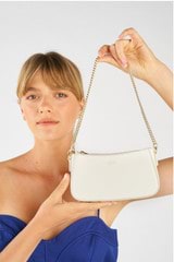 Profile view of model wearing the Oroton Inez Chain Wristlet in Cream and Saffiano Leather for Women