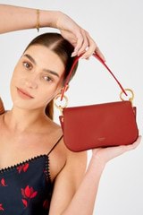 Profile view of model wearing the Oroton Liv Small Day Bag in Dark Poppy and Pebble leather for Women