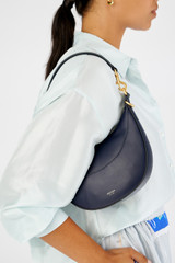 Profile view of model wearing the Oroton Florence Small Shoulder Bag in North Sea and Smooth leather for Women