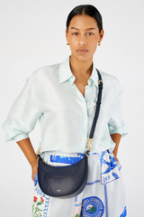 Profile view of model wearing the Oroton Florence Small Shoulder Bag in North Sea and Smooth leather for Women