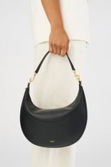 Profile view of model wearing the Oroton Florence Medium Hobo in Black and Smooth leather for Women