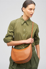 Profile view of model wearing the Oroton Florence Medium Hobo in Cognac and Smooth leather for Women