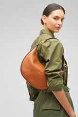 Profile view of model wearing the Oroton Florence Medium Hobo in Cognac and Smooth leather for Women