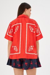 Profile view of model wearing the Oroton Daisy Print Camp Shirt in Poppy and 100% silk for Women