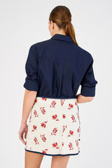 Profile view of model wearing the Oroton Dutch Tulip Wrap Skirt in Ecru and 100% linen for Women