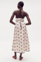 Profile view of model wearing the Oroton Dutch Tulip Halter Sundress in Ecru and 100% linen for Women