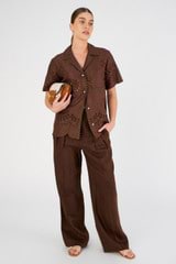 Profile view of model wearing the Oroton Tab Detail Pleat Pant in Espresso and 100% linen for Women