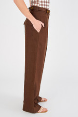 Profile view of model wearing the Oroton Tab Detail Pleat Pant in Espresso and 100% linen for Women