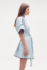 Profile view of model wearing the Oroton Contrast Trim Smock Dress in Pale Blue and 100% linen for Women