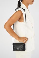 Profile view of model wearing the Oroton Elvie Crossbody in Black and Smooth leather for Women