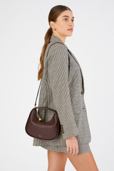 Profile view of model wearing the Oroton Clara Mini Bag in Bear Brown and Pebble leather for Women