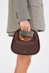 Profile view of model wearing the Oroton Clara Mini Bag in Bear Brown and Pebble leather for Women