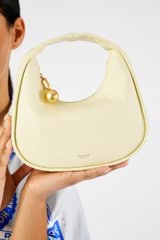 Profile view of model wearing the Oroton Clara Texture Small Day Bag in Lemon Butter and Ostish embossed leather for Women