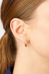 Profile view of model wearing the Oroton Caterina Medium Hoop in 18K Gold and Recycled 925 Sterling Silver for Women