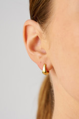 Profile view of model wearing the Oroton Caterina Huggie in 18K Gold and Recycled 925 Sterling Silver for Women
