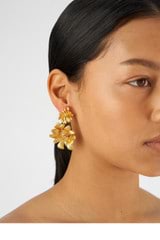 Profile view of model wearing the Oroton Peony Drop Earrings in Worn Gold and Brass for Women