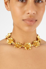Profile view of model wearing the Oroton Peony Necklace in Worn Gold and Brass for Women